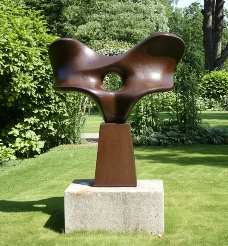 Large brown patina bronze sculpture outdoors in a park.